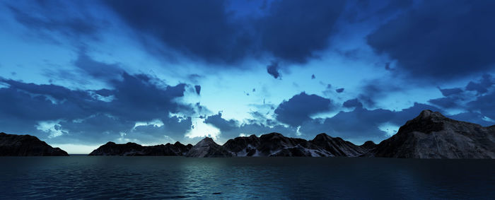 Panoramic view of sea and mountains against blue sky