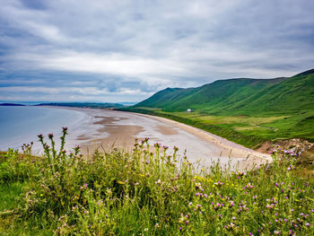 Scenic view of sea and mountains against sky