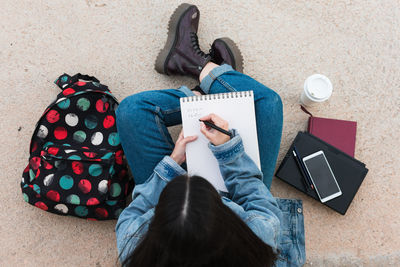 Top view of a college student while she writes in her notebook