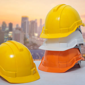 Close-up of yellow hat on mirror at construction site