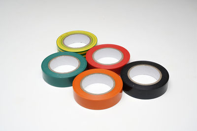 High angle view of multi colored adhesive tapes on gray background