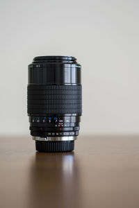 Close-up of camera on table against white background