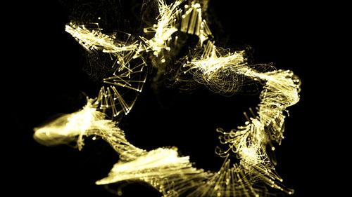 Close-up of illuminated lighting equipment against black background