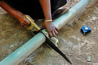 High angle view of man working on barbecue grill