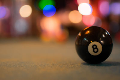 Close-up of pool ball on illuminated street