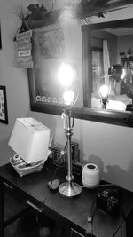 Illuminated lamp on table in house