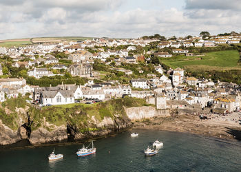 High angle view of townscape by sea against sky