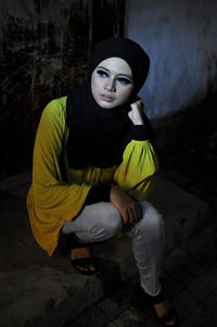 Portrait of a young woman sitting outdoors