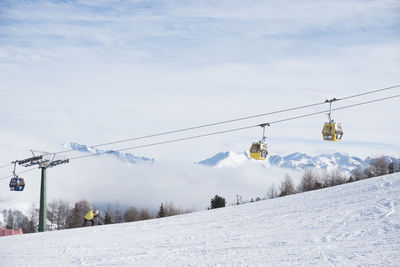 Overhead cable car against sky during winter