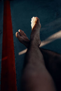 Low section of person relaxing on floor