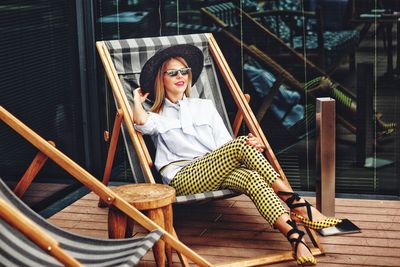 Portrait of smiling young woman sitting outdoors