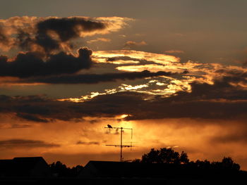 Silhouette of landscape against cloudy sky