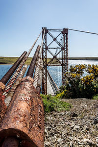 Rusty metallic bridge against sky