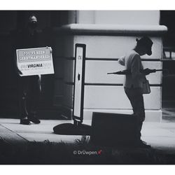 Rear view of man holding text