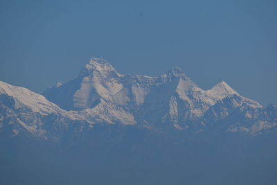 Scenic view of snowcapped mountains against clear sky