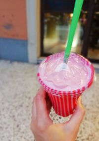 Close-up of hand holding ice cream