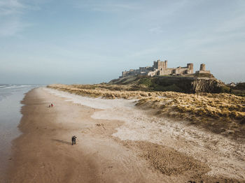 Scenic view of beach by sea against sky