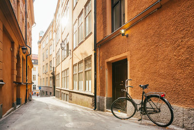 Bicycle parked on street amidst buildings