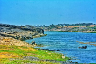 Scenic view of sea against clear blue sky