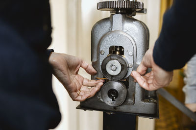 Midsection of man holding camera