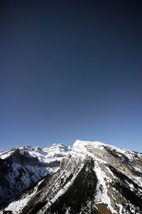 Scenic view of snowcapped mountains against clear sky