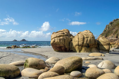 Rocks on beach against sky