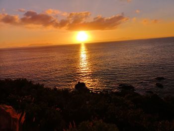 Scenic view of sea against romantic sky at sunset