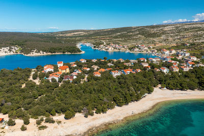 High angle view of townscape by sea against sky