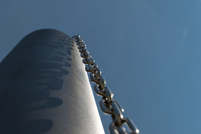 Low angle view of chain against sky