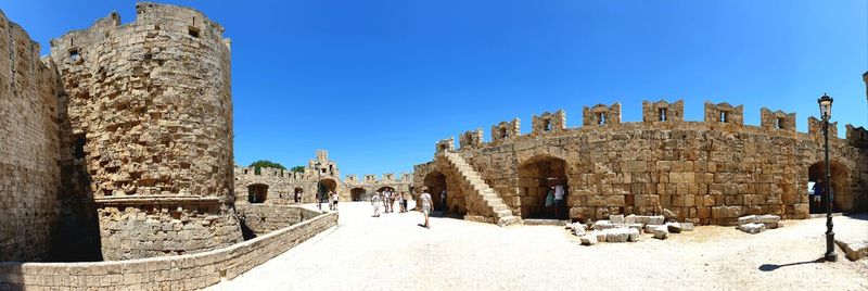 Panoramic view of historical building against clear blue sky