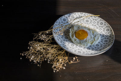 High angle view of egg in plate on table