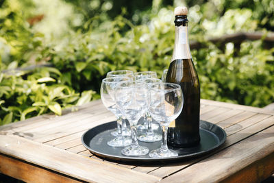 Close-up of wine glasses and bottle on table