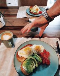Cropped image of man holding breakfast