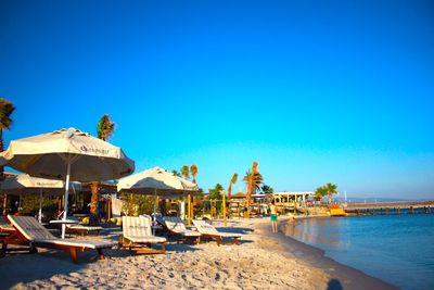 Panoramic view of beach against clear blue sky