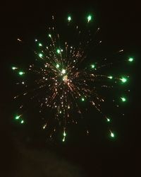 Low angle view of firework display at night