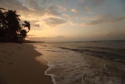 Scenic view of beach against sky during sunset