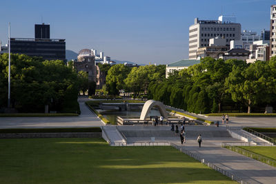 Park in city against clear sky