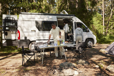 People preparing meal at camp site