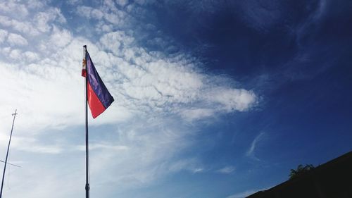 Low angle view of philippines flag against blue sky