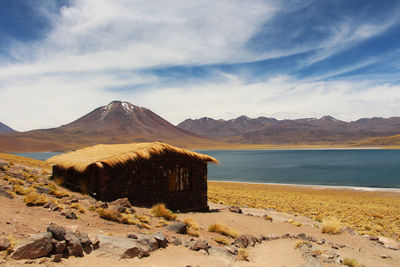 Scenic view of sea and mountains against sky