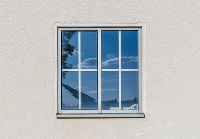 Low angle view of glass window of building