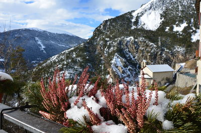 Snowed rocky mountain against clouds