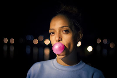 Close-up portrait of a teenage girl at night