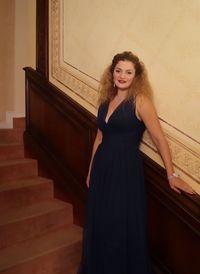 Portrait of smiling woman standing on staircase