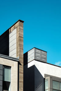 Low angle view of building against clear blue sky