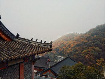 Houses against sky during autumn