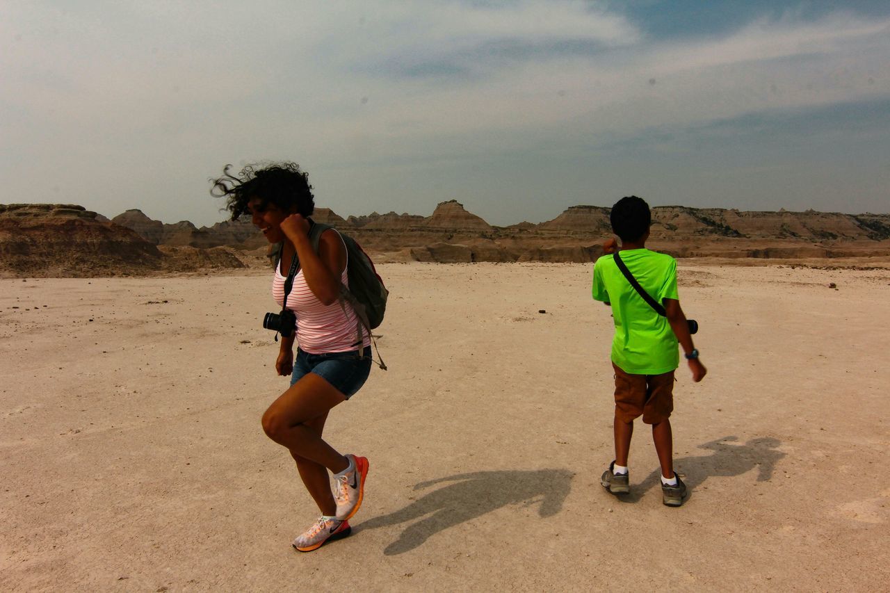 full length, lifestyles, leisure activity, sand, casual clothing, sky, rear view, men, walking, desert, togetherness, boys, beach, landscape, childhood, sunlight, bonding