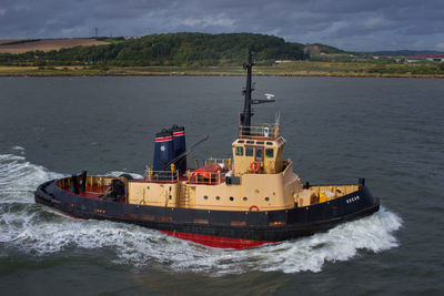 Ship sailing on sea against sky