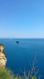 Scenic view of sea against clear blue sky