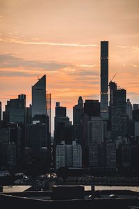 Silhouette buildings against sky during sunset